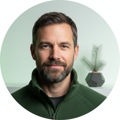 Portrait of Bram Vossen, a rugged man with a beard, wearing a FROVIK Outdoor Fleece Jacket, against a softly lit background.